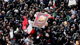 Iranian mourners lift a picture of slain military commander Qasem Soleimani during a funeral procession in the capital Tehran on January 6, 2020.