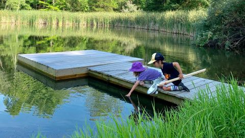 Higgins' twin five-year olds play at a pond on their upstate New York vacation property.