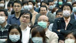 HONG KONG - APRIL 16:  People wear masks to protect themselves against the Severe Acute Respiratory Syndrome (SARS) virus April 16, 2003 in Hong Kong. The mystery virus has killed 154 people and infected 3,437 worldwide, according to the World Health Organization.  (Photo by Christian Keenan/Getty Images)