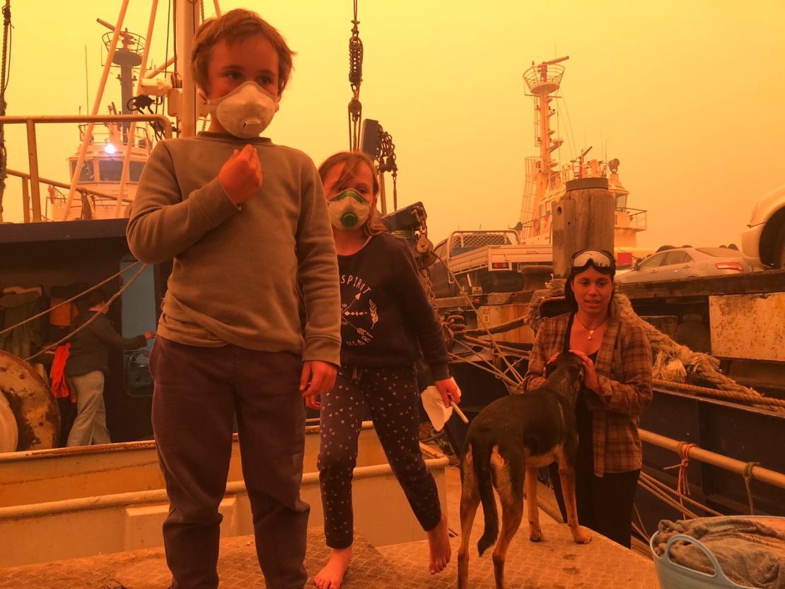 Ike, 5, and his sister Kalani, 6, with their mother Louise during a tense weekend on the family's fishing vessel where they took shelter from flames in Eden, NSW.