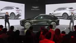 Aston Martin executives speak at the world premiere of the Aston Martin DBX SUV in Beijing on November 20, 2019. - Aston Martin launched its first ever SUV in the Chinese capital on November 20.