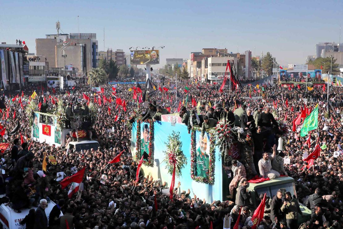 The coffins of Qasem Soleimani and others killed in a US drone strike are carried by mourners in Kerman, Iran, on Tuesday.