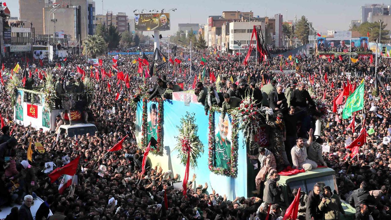 The coffins of Qasem Soleimani and others killed in a US drone strike are carried by mourners in Kerman, Iran, on Tuesday.
