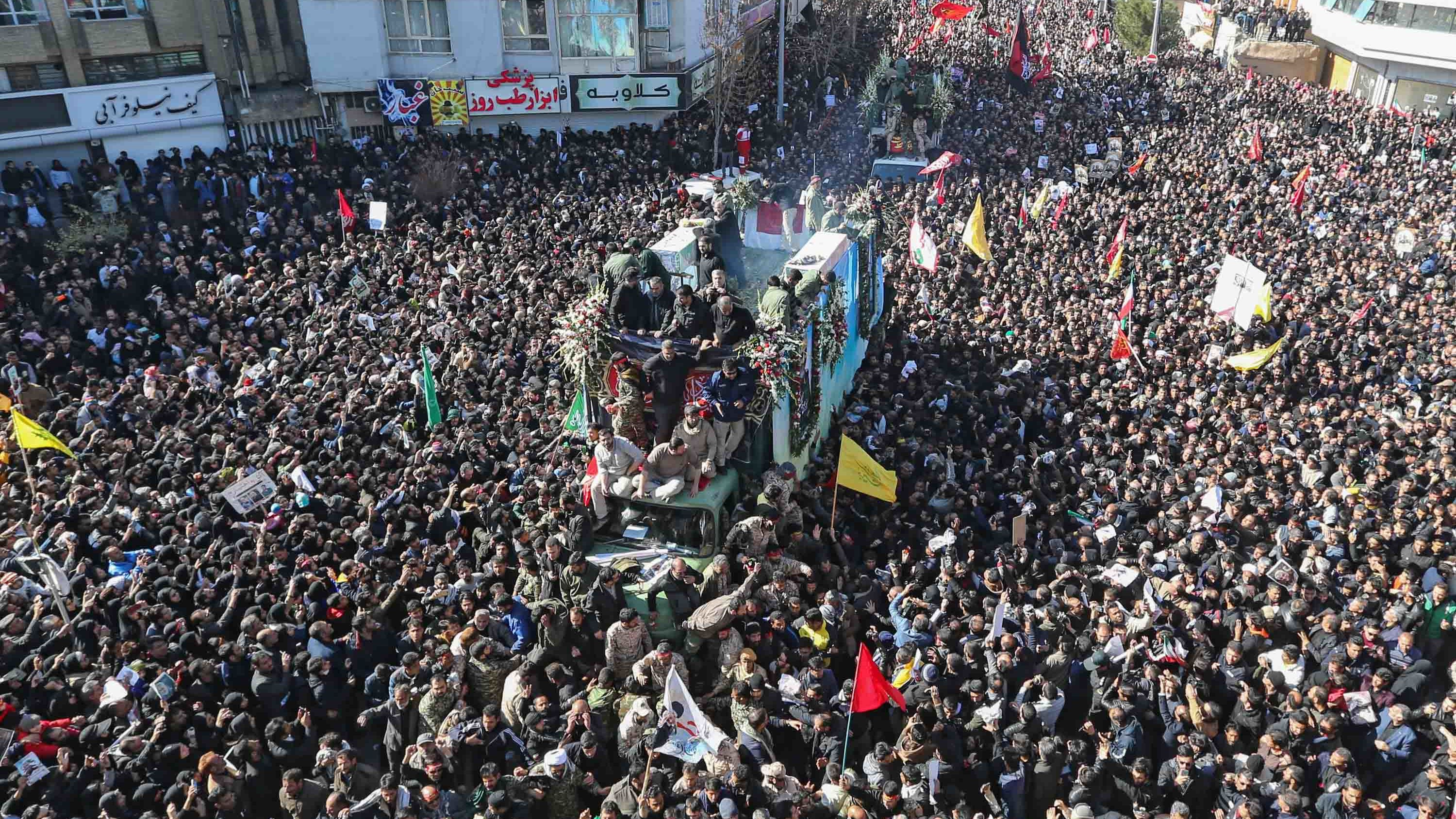 Iranian mourners gather around a vehicle carrying the coffin of slain top general Qasem Soleimani during the final stage of funeral processions, in his hometown Kerman on January 7, 2020.