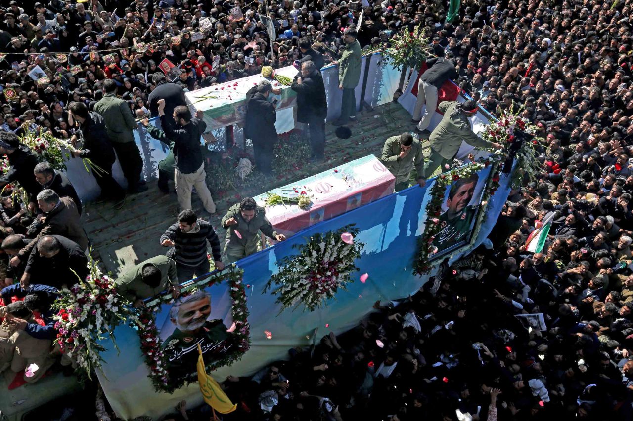 A vehicle carrying Soleimani's remains makes its way through a crowd in Kerman.