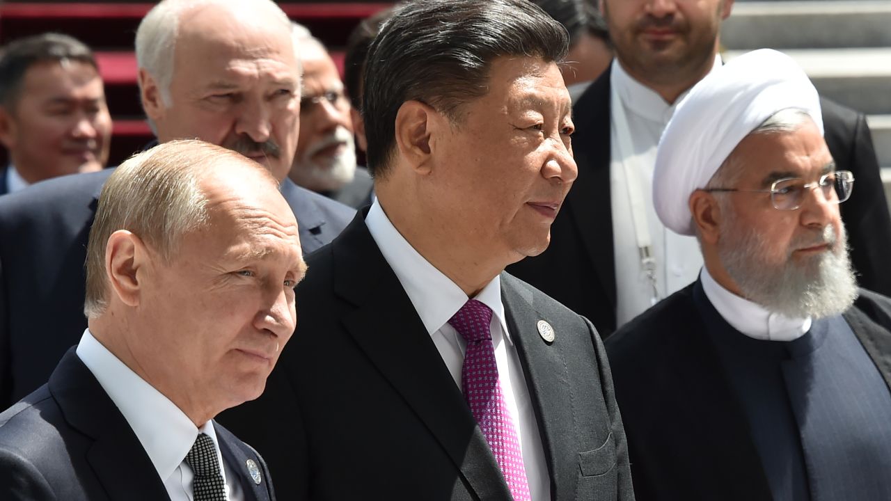 Russian President Vladimir Putin, Chinese President Xi Jinping and Iran's President Hassan Rouhani walk attend a meeting of the Shanghai Cooperation Organisation (SCO) Council of Heads of State in Bishkek on June 14, 2019. 
