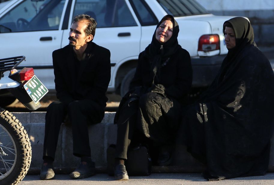 Relatives of victims that were caught in a stampede wait outside a hospital in Kerman on January 7.