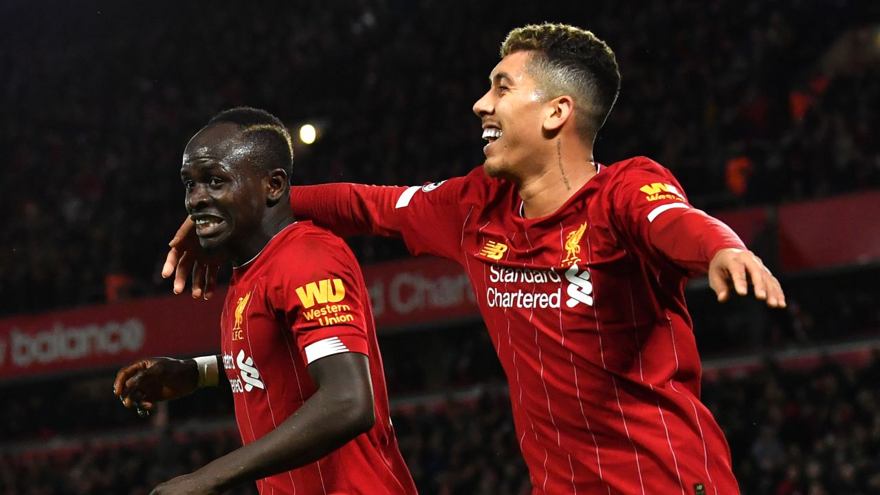 Mane (left) celebrates scoring against Sheffield United with teammate Roberto Firmino.