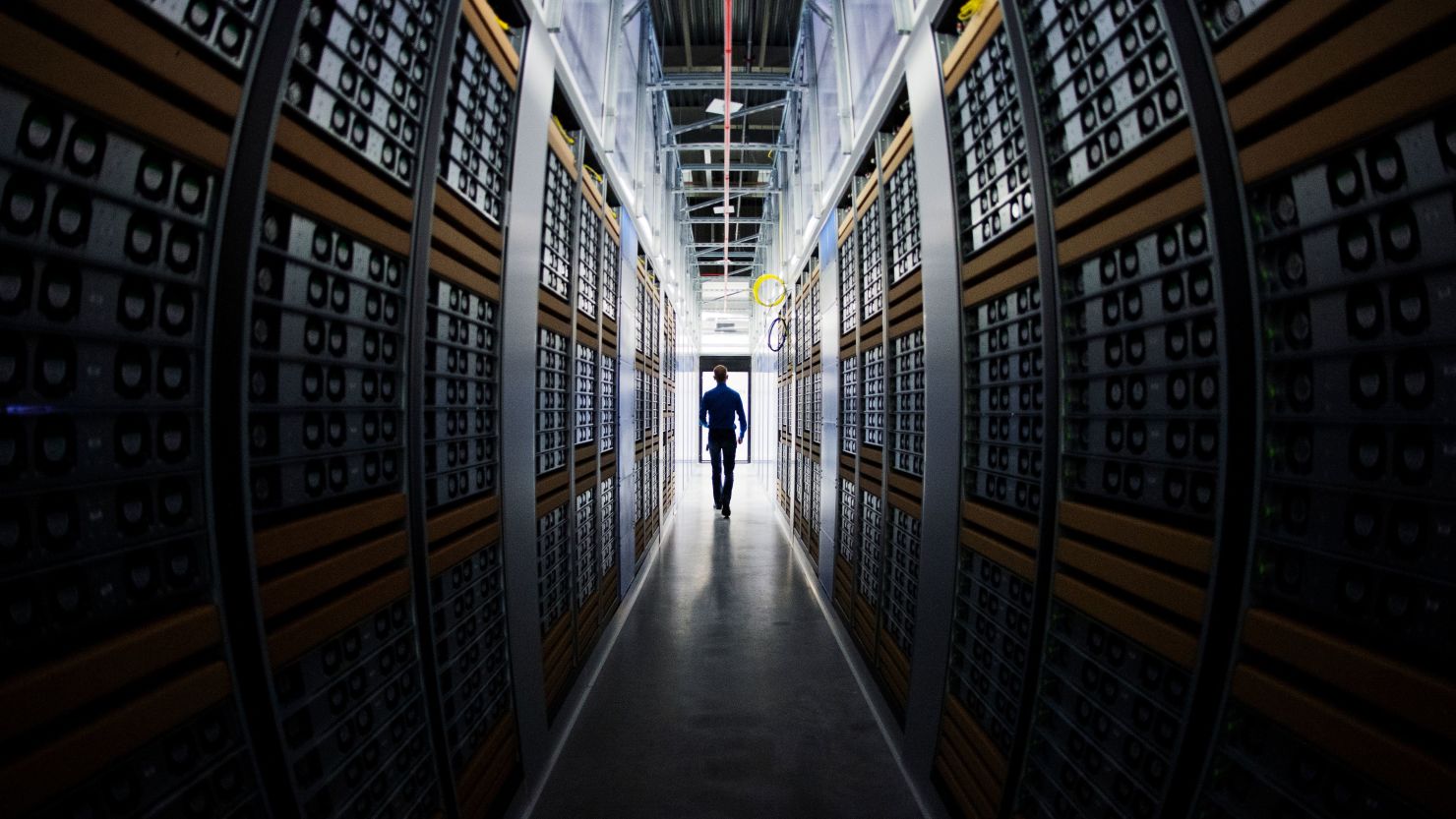 A worker walks in one of the server rooms at a Facebook Data Center in Swedish Lapland in 2013.