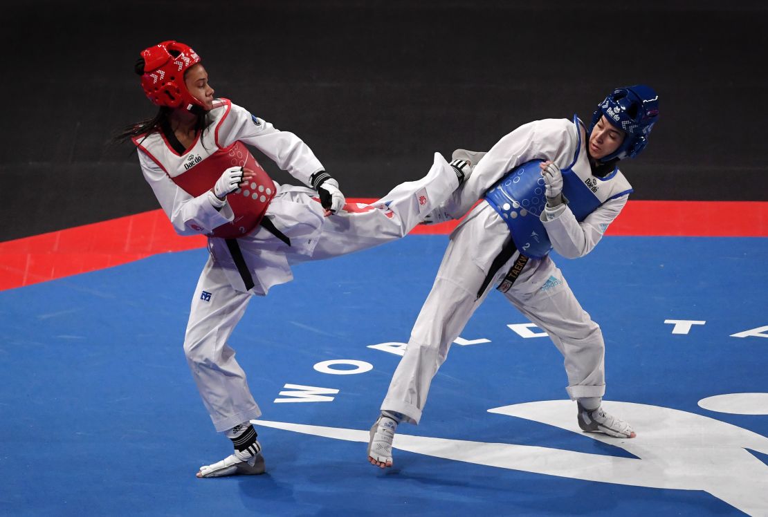 Aaliyah Powell (right) dodges a kick from Morocco's Oumaima El Bouchti on her way to winning bantamweight gold at the 2019 World Taekwondo Championships.