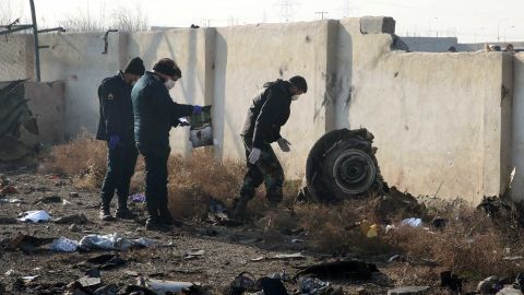 Rescue teams work amidst debris after a Ukrainian plane carrying 176 passengers crashed near Imam Khomeini airport in the Iranian capital Tehran early in the morning on January 8, 2020, killing everyone on board. - All 176 people on board a Ukrainian passenger plane were killed when it crashed shortly after taking off from Tehran on January 8, Iranian state media reported. State news agency IRNA said 167 passengers and nine crew members were on board the aircraft operated by Ukraine International Airlines. (Photo by - / AFP) (Photo by -/AFP via Getty Images)