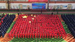 Pupils form China's national flag during assembly in Jinan, in China's eastern Shandong province, on March 5, 2018.