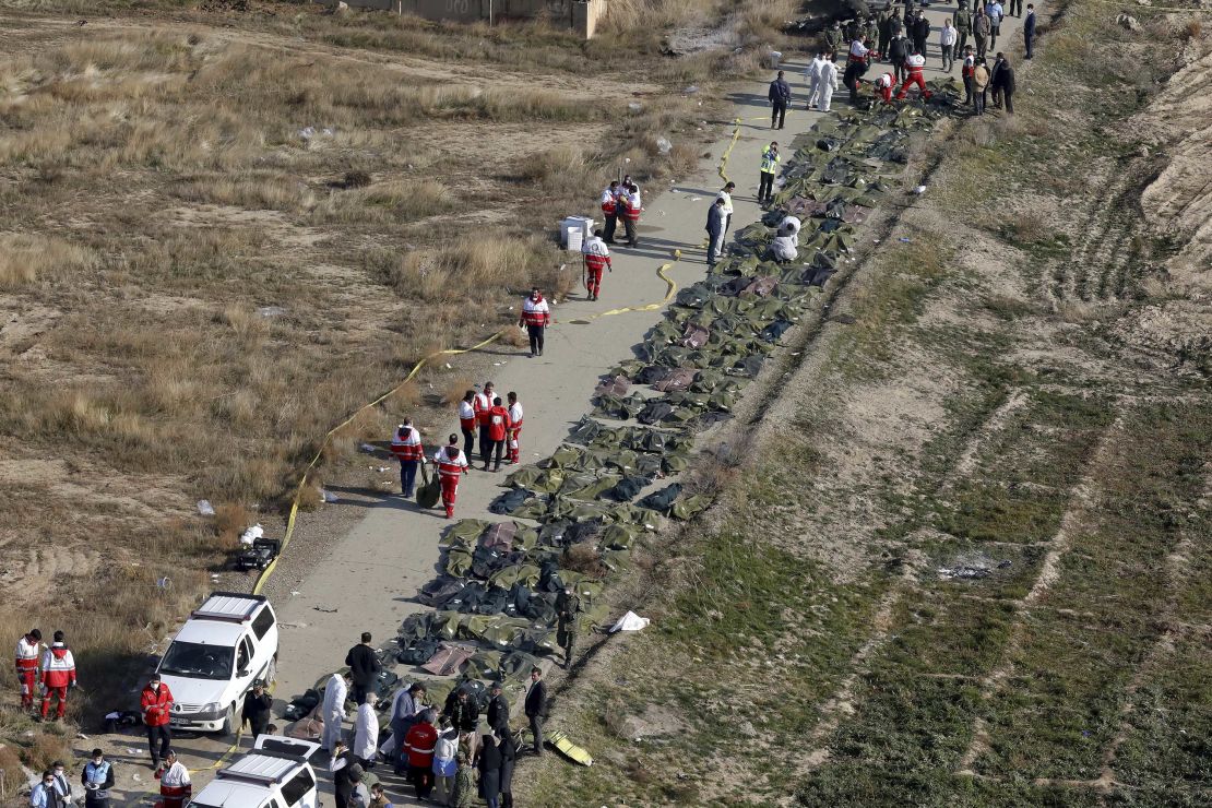 Rescuers line up the bodies of victims of a Ukrainian plane crash in Shahedshahr, Iran, on Wednesday.