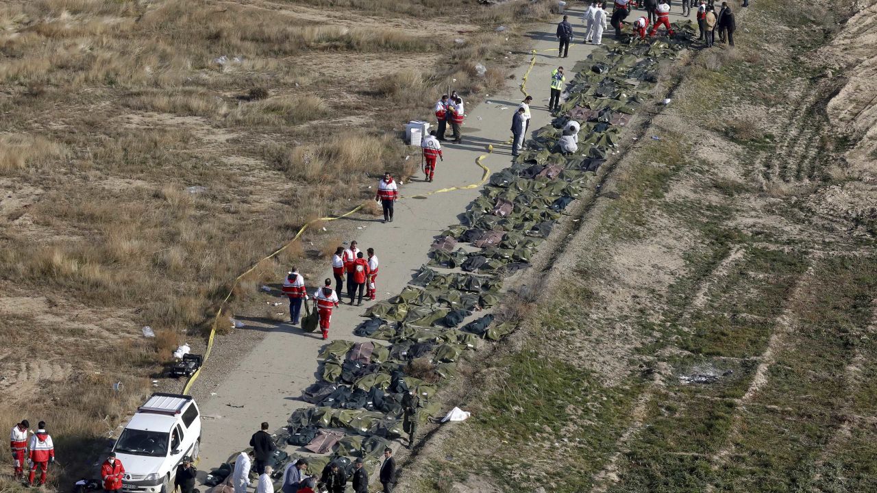 Rescuers line up the bodies of victims of a Ukrainian plane crash in Shahedshahr, Iran, on Wednesday.