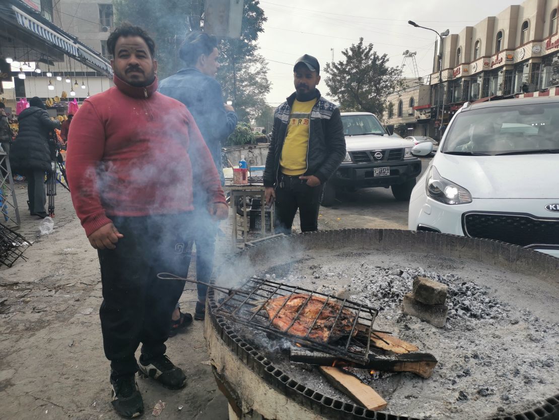 Mohammed Hammed, 30, grills fish on a sidewalk in central Baghdad. He says the Iranian strike on Wednesday was "absolutely wrong."