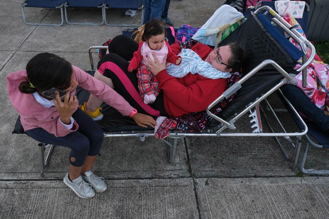 Tatiana Rodriguez, right, rests at a refuge center with her family.