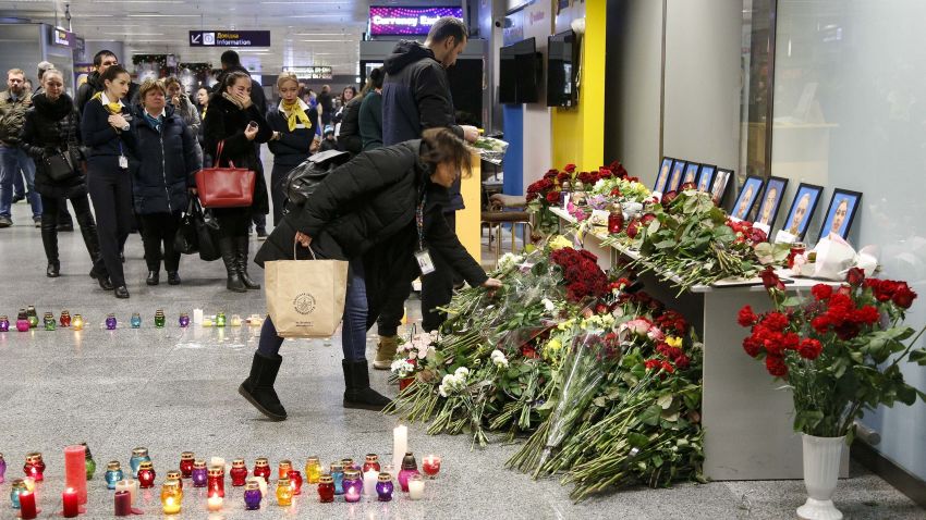 Relatives and friends of the flight crew members of the Ukrainian 737-800 plane that crashed on the outskirts of Tehran, lay flowers at a memorial inside Borispil international airport outside Kyiv, Ukraine, Wednesday, Jan. 8, 2020. A Ukrainian airplane carrying 176 people crashed on Wednesday shortly after takeoff from Tehran's main airport, killing all onboard, Iranian state TV and officials in Ukraine said. (AP Photo/Efrem Lukatsky)