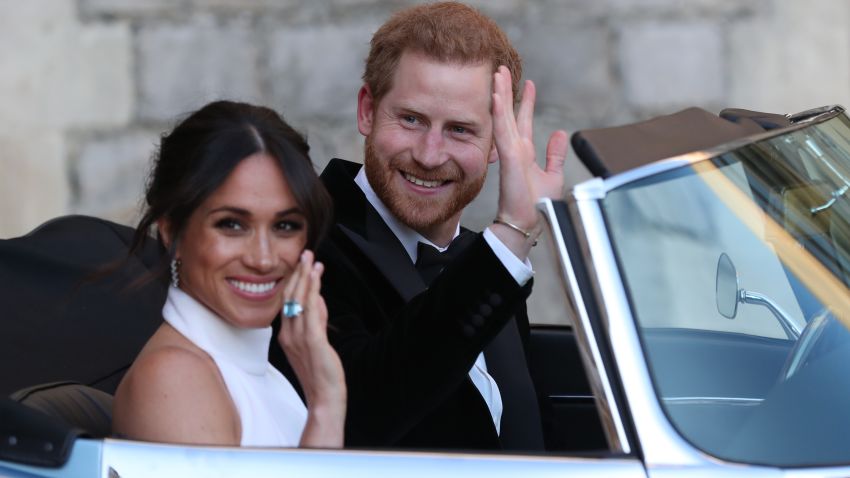 WINDSOR, UNITED KINGDOM - MAY 19: Duchess of Sussex and Prince Harry, Duke of Sussex wave as they leave Windsor Castle after their wedding to attend an evening reception at Frogmore House, hosted by the Prince of Wales on May 19, 2018 in Windsor, England. (Photo by Steve Parsons/WPA Pool/Getty Images)