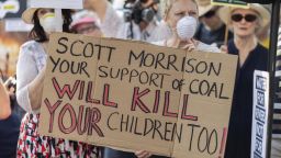 Demonstrators attend a climate protest in Sydney on December 19, 2019. - Protesters marched on Australian Prime Minister Scott Morrison's official residence in Sydney to demand curbs on greenhouse gas emissions and highlight his absence on an overseas holiday as bushfires burned across the region. (Photo by Wendell TEODORO / AFP) (Photo by WENDELL TEODORO/AFP via Getty Images)