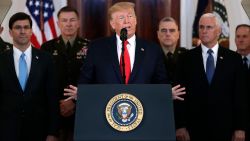 President Donald Trump addresses the nation from the White House on the ballistic missile strike that Iran launched against Iraqi air bases housing U.S. troops, Wednesday, Jan. 8, 2020, in Washington, as Vice President Mike Pence and others looks on. (AP Photo/ Evan Vucci)
