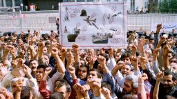Thousands of Iranians chanting "Death to America," participate in a mass funeral for 76 people killed when the USS Vincennes shot down Iran Air Flight 655, in Tehran, Iran, July 7, 1988. They hold aloft a drawing depicting the incident. 290 people were killed in the July 3, 1988 incident. (AP Photo/CP/Mohammad Sayyad)