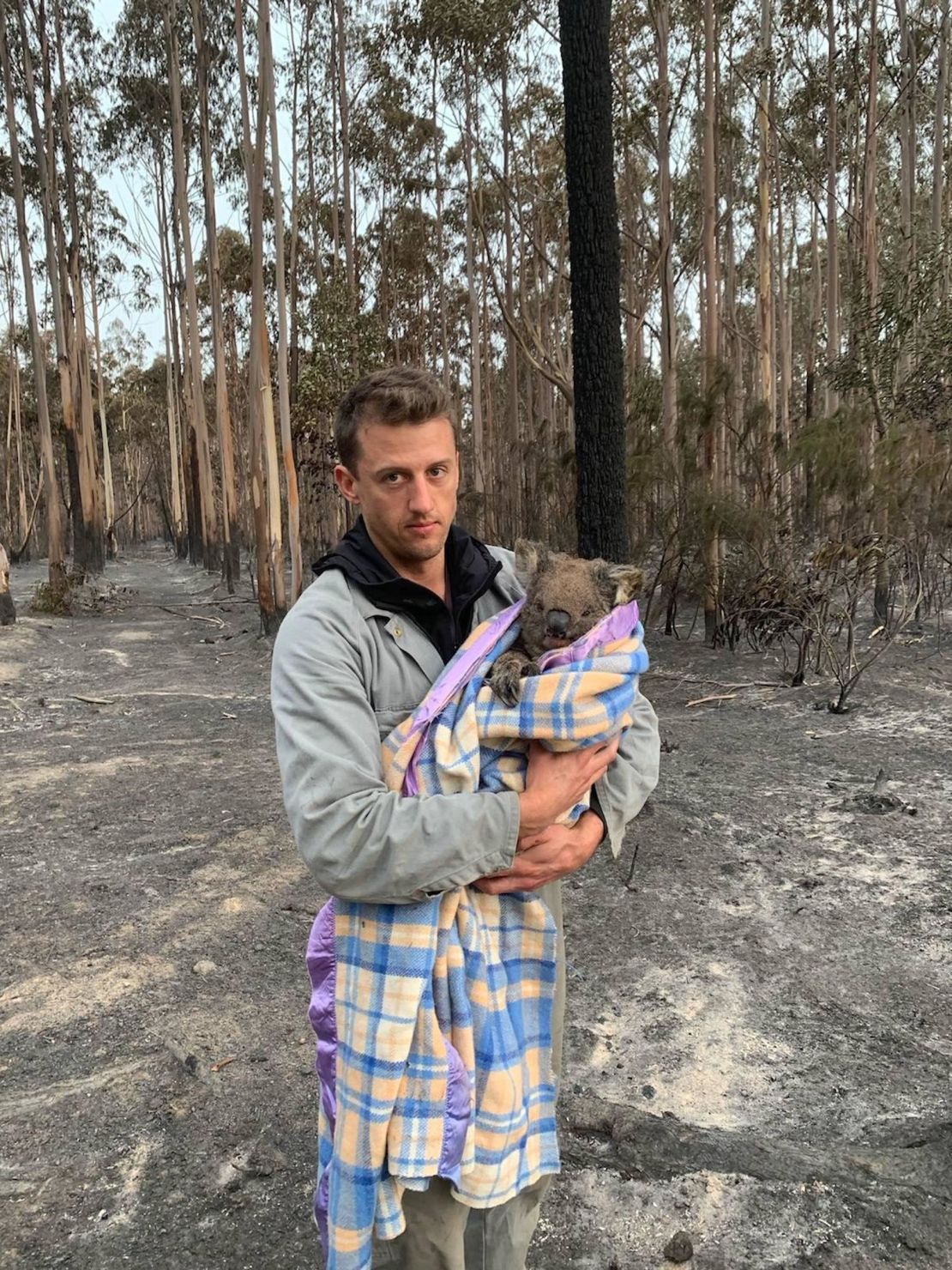 Jack Bruce holds Wilbur, a koala rescued from the fires, who he and his partner Alyex Burges are helping rehome. 