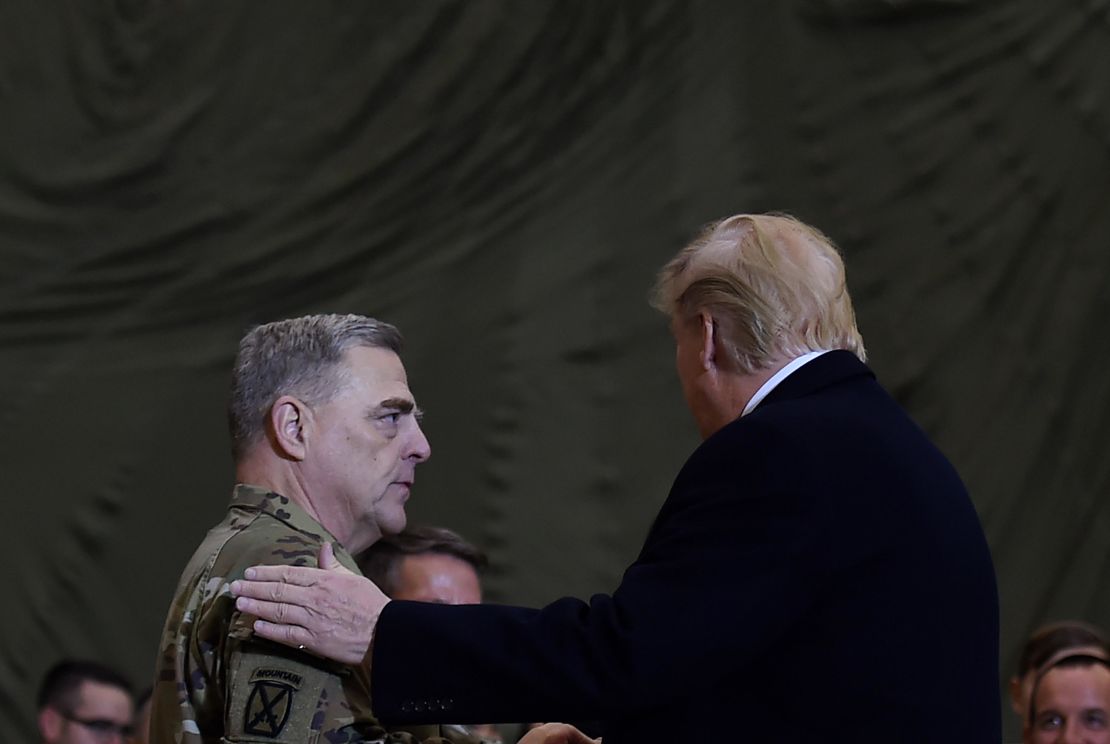 US President Donald Trump shakes hands with Joint Chiefs Chairman General Mark Milley after addressing the troops at Bagram Air Field during a surprise Thanksgiving day visit, on November 28, 2019 in Afghanistan.
