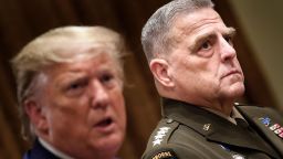 Chairman of the Joint Chiefs of Staff Army General Mark A. Milley (R) listens while US President Donald Trump speaks before a meeting with senior military leaders in the Cabinet Room of the White House in Washington, DC on October 7, 2019. 