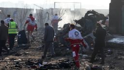 Rescue teams work amidst debris after a Ukrainian plane carrying 176 passengers crashed near Imam Khomeini airport in the Iranian capital Tehran early in the morning on January 8, 2020, killing everyone on board. - The Boeing 737 had left Tehran's international airport bound for Kiev, semi-official news agency ISNA said, adding that 10 ambulances were sent to the crash site. (Photo by - / AFP) (Photo by -/AFP via Getty Images)