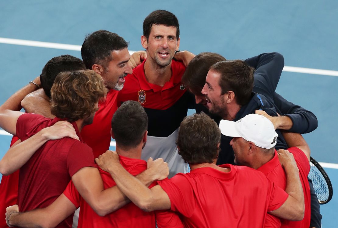 Novak Djokovic celebrates with his Serbia teammates after sending the team into the ATP Tour Cup finals.