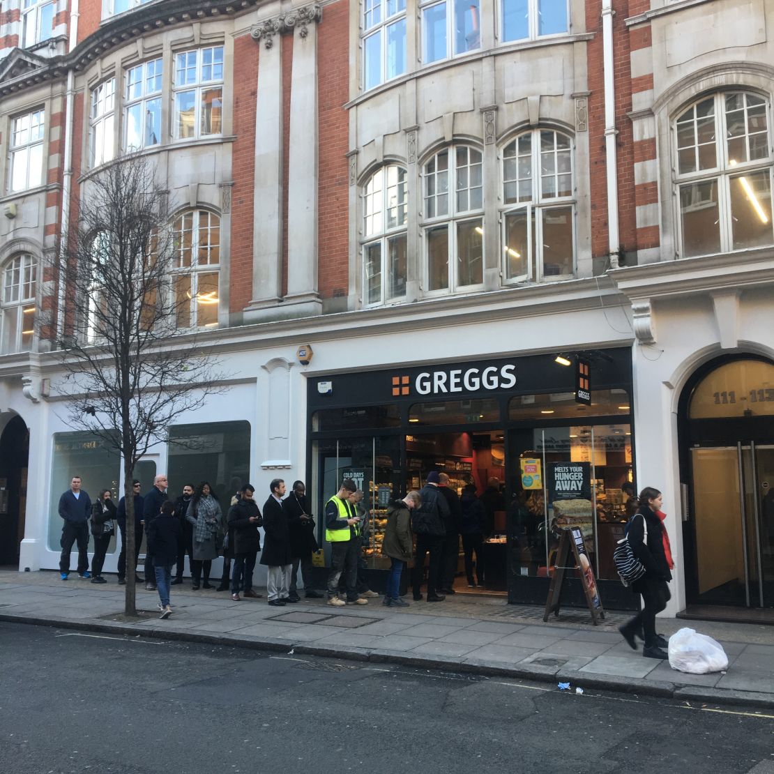 Customers queue outside a London Greggs at lunchtime.