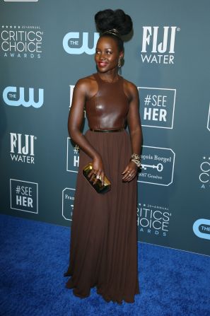 Lupita Nyong'o arrives for the Critics' Choice Awards in an elegant Michael Kors dress paired with vintage accessories. 