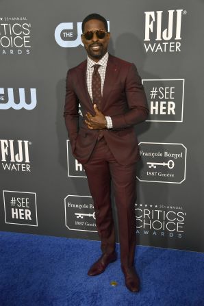 Sterling K. Brown arrives in a fetching maroon suit.