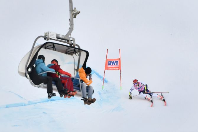Spectators on a ski lift watch Zan Kranjec race in the men's giant slalom of the FIS World Cup in Adelboden, Switzerland, on Saturday, January 11.