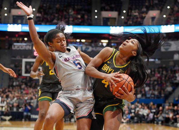 UConn guard Crystal Dangerfield, left, fouls Baylor's Te'a Cooper during the first half of their NCAA basketball game in Hartford on Thursday, January 9. Baylor won the game 70-54, <a href="index.php?page=&url=https%3A%2F%2Fbleacherreport.com%2Farticles%2F2870604-no-1-uconn-upset-by-no-6-baylor-74-58-snaps-huskies-98-game-home-win-streak" target="_blank" target="_blank">snapping UConn's 98-game winning streak at home</a>, only one game shy of the Division I record of 99 games, which is also held by UConn.