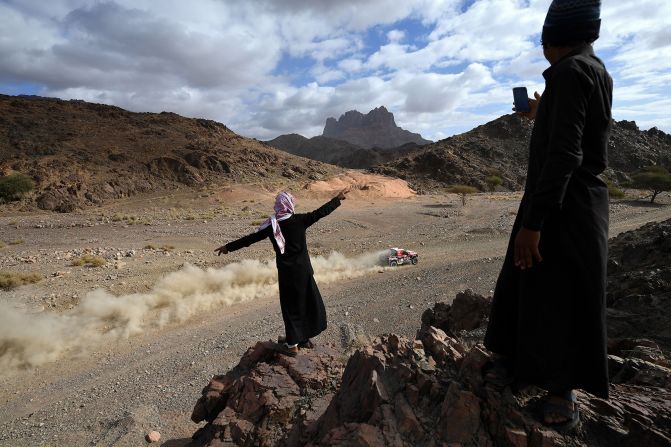 People gesture as Ford's Czech driver Martin Prokop and co-driver Viktor Chytka compete in Stage 4 of the 2020 Dakar Rally in Saudi Arabia, on Wednesday, January 8.