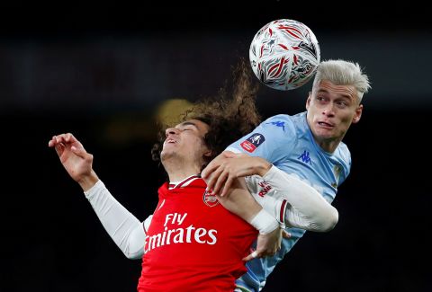 Arsenal's Matteo Guendouzi vies for the ball with Leeds United's Ezgjan Alioski during their match on Monday, January 6, in London. Arsenal defeated Leeds United 1-0.