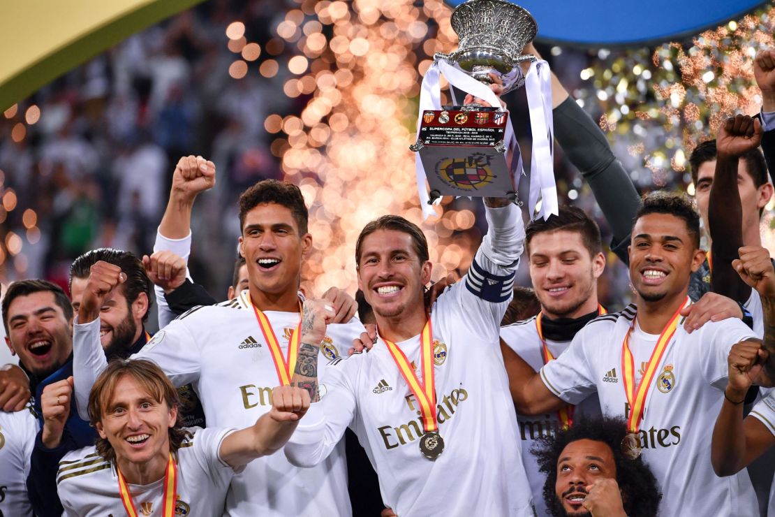 Real Madrid captain Sergio Ramos raises the trophy after scoring the winning penalty. 