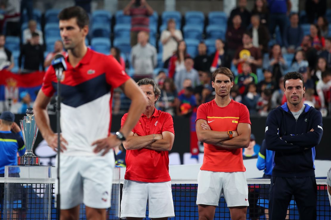 Rafa Nadal looks on as Novak Djokovic gives his victory speech following the ATP Cup final. 