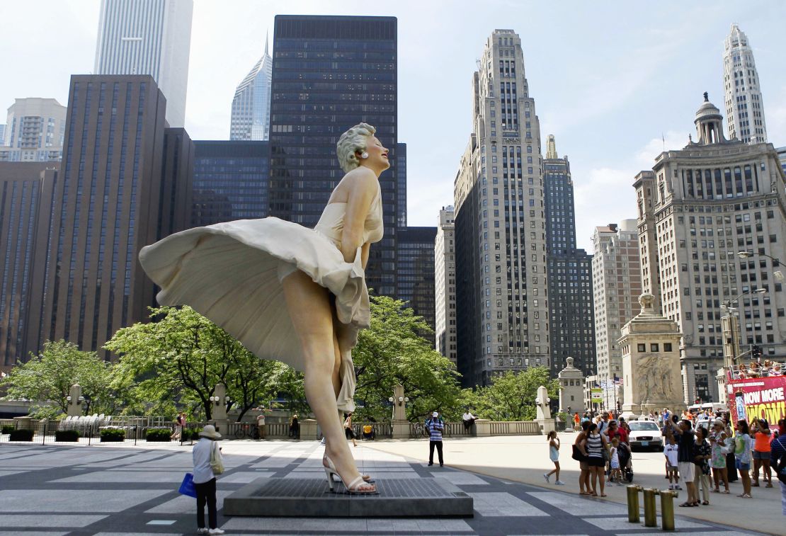 Spectators gather around Seward Johnson's 26-foot-tall sculpture of Marilyn Monroe.