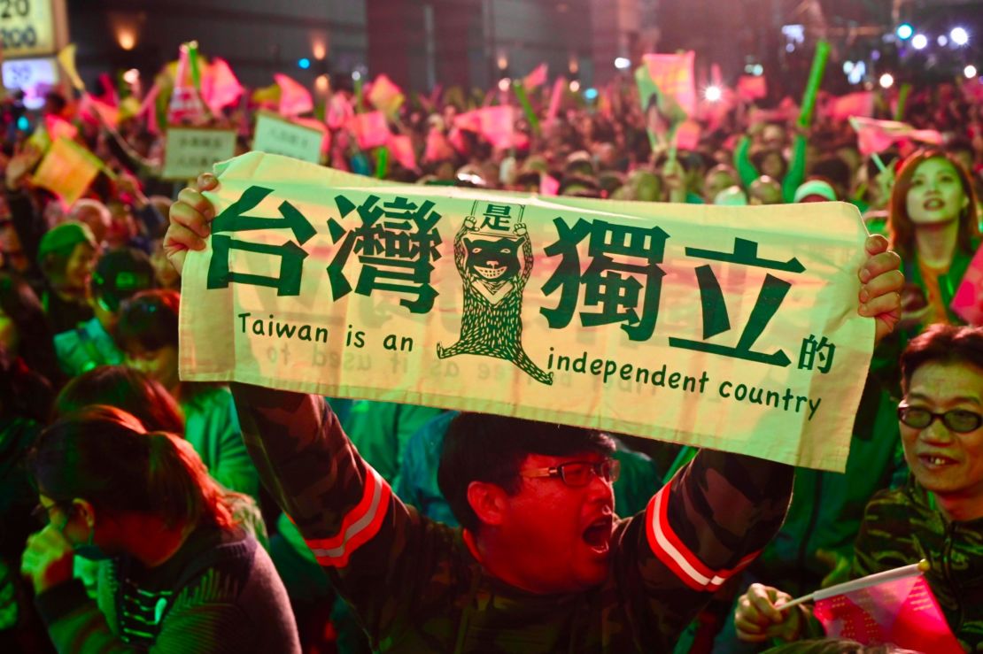 A supporter of Taiwan President Tsai Ing-wen displays a banner outside the campaign headquarters in Taipei on January 11, 2020.