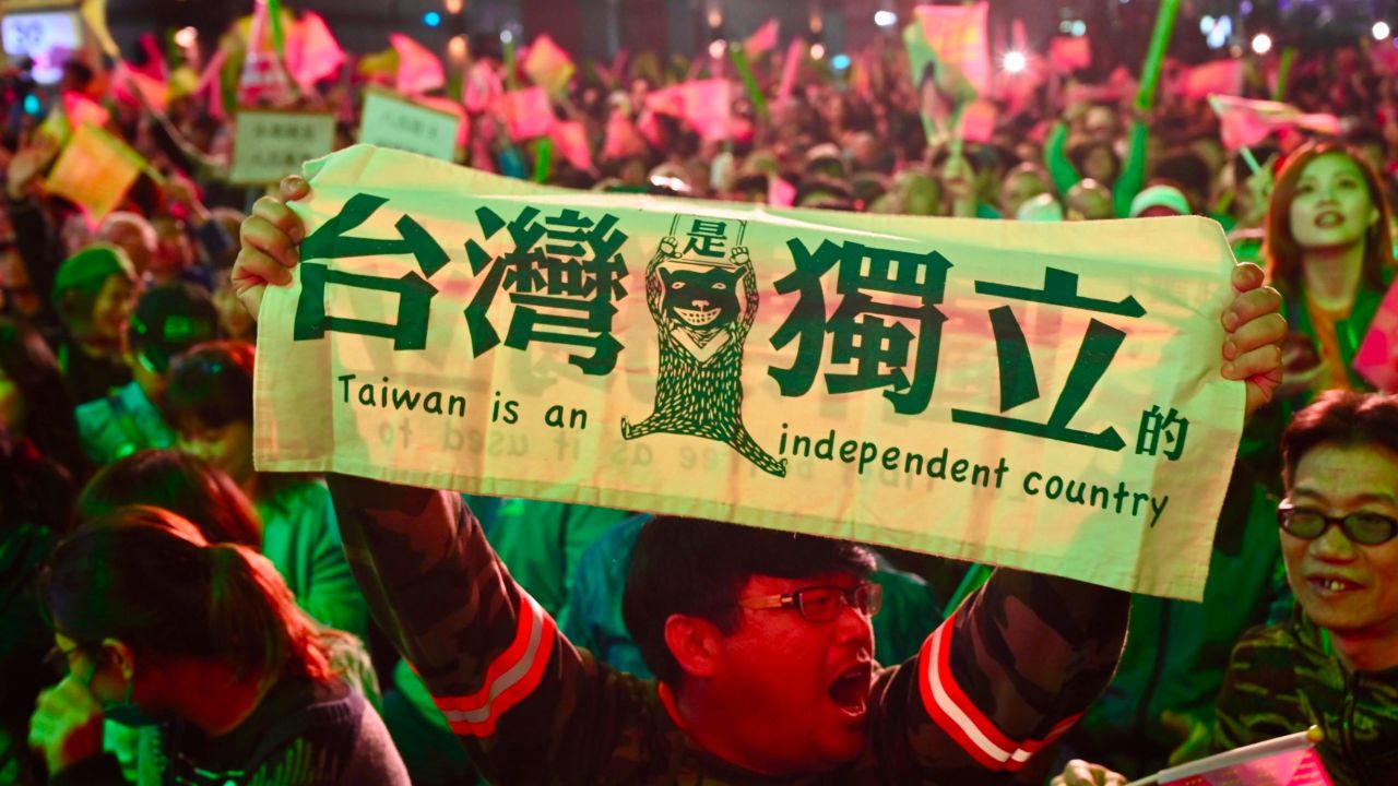 A supporter of Taiwan President Tsai Ing-wen displays a banner outside the campaign headquarters in Taipei on January 11, 2020.