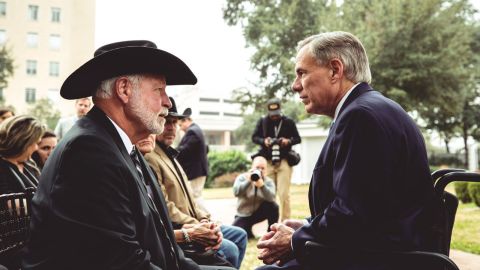 Gov. Greg Abbott speaks with Jack WIlson before Monday's medal ceremony.
