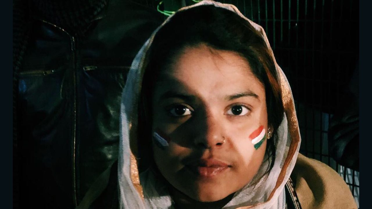 A demonstrator sports a headscarf and an Indian flag painted on her face in Shaheen Bagh, a neighborhood in the Indian capital of New Delhi, on December 27, 2019.