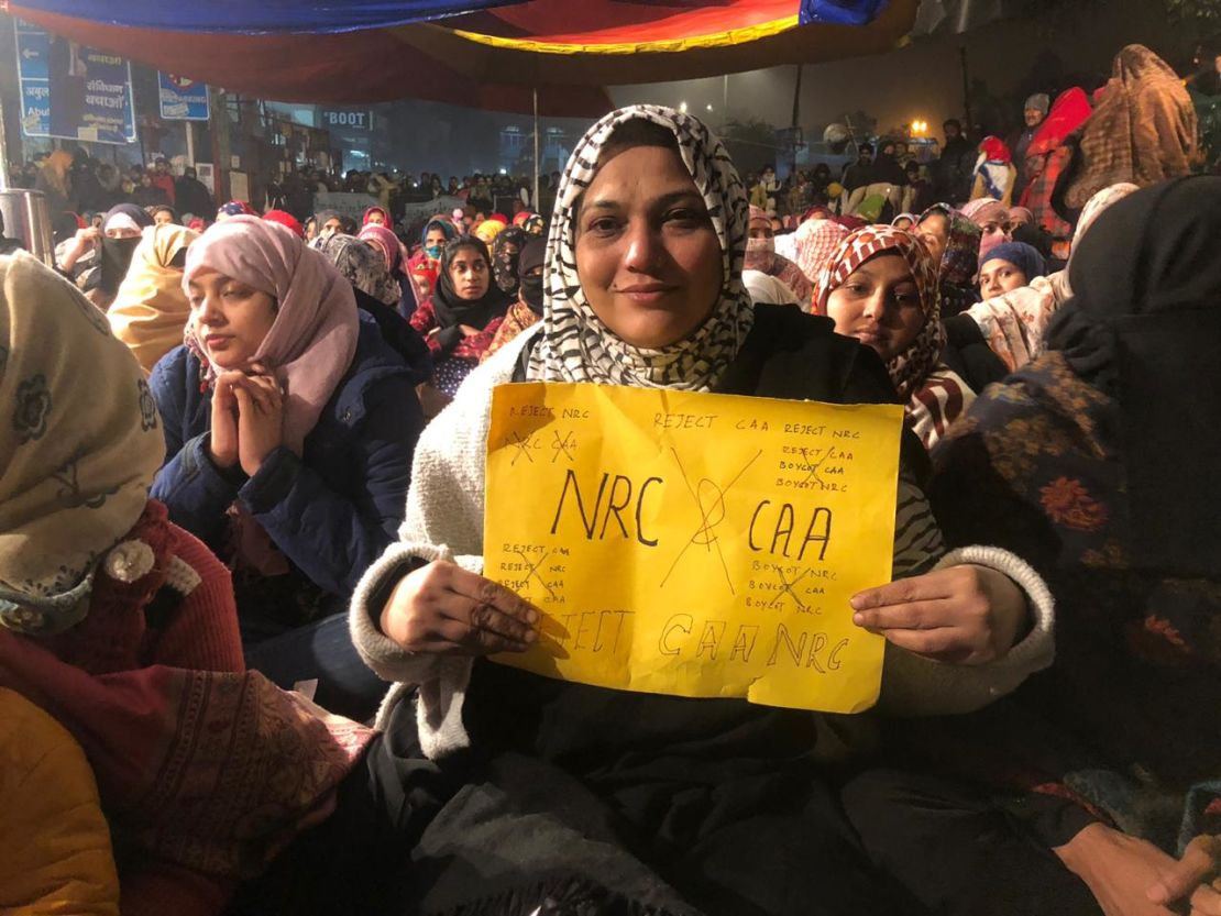 A woman holds a protest sign on December 27, 2019, at Shaheen Bagh, a neighborhood in the Indian capital of New Delhi where women have been staging a peaceful sit in. 