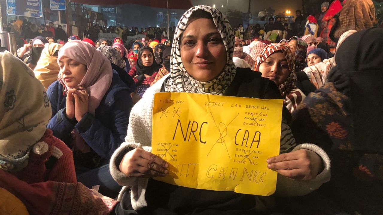 A woman holds a protest sign on December 27, 2019, at Shaheen Bagh, a neighborhood in the Indian capital of New Delhi where women have been staging a peaceful sit in.