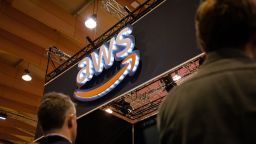 People pass by AWS (Amazon Web Services) stand during the day 3 of the annual Web Summit technology conference in Lisbon.
