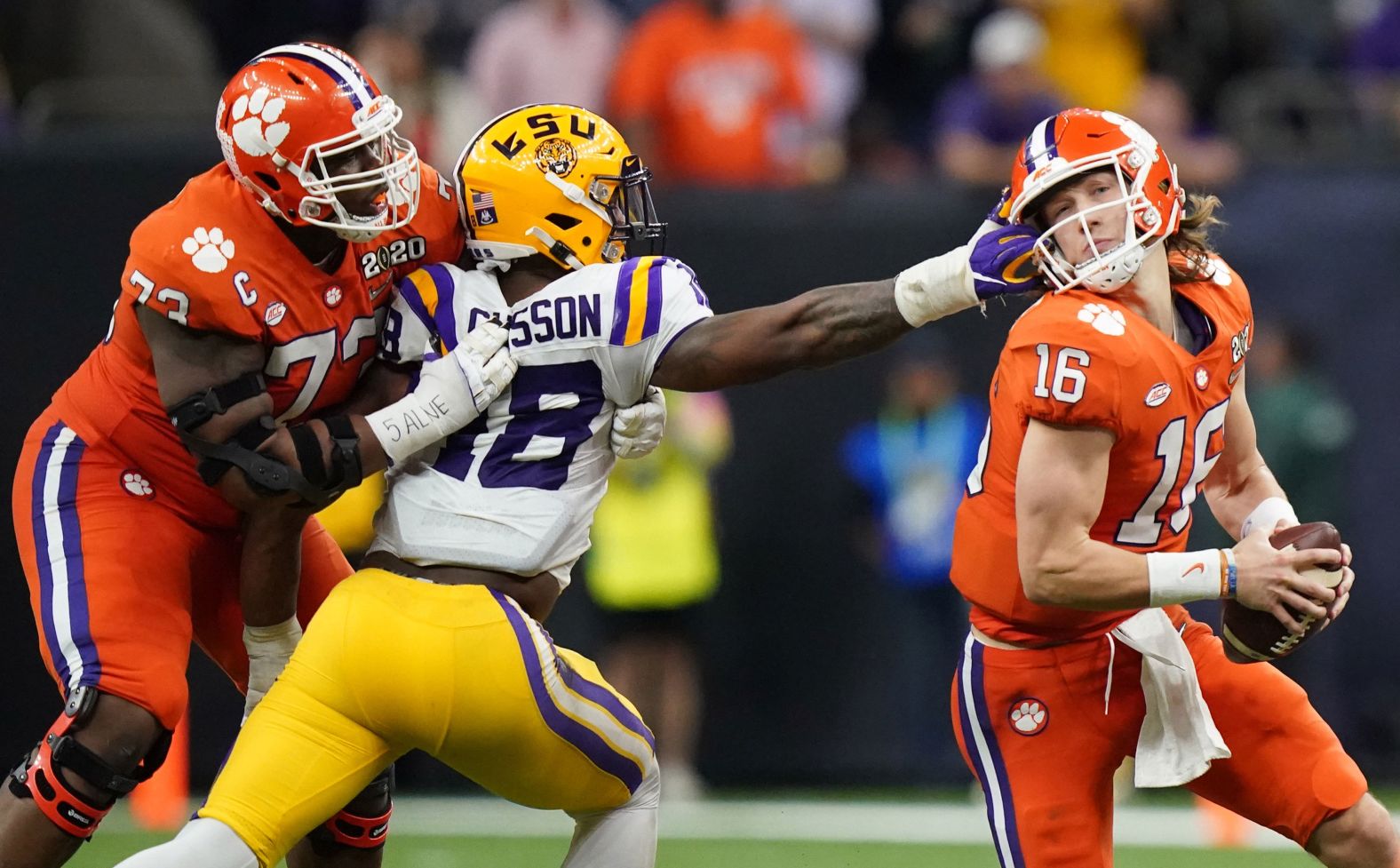 LSU linebacker K'Lavon Chaisson grabs Lawrence's face mask in the third quarter.