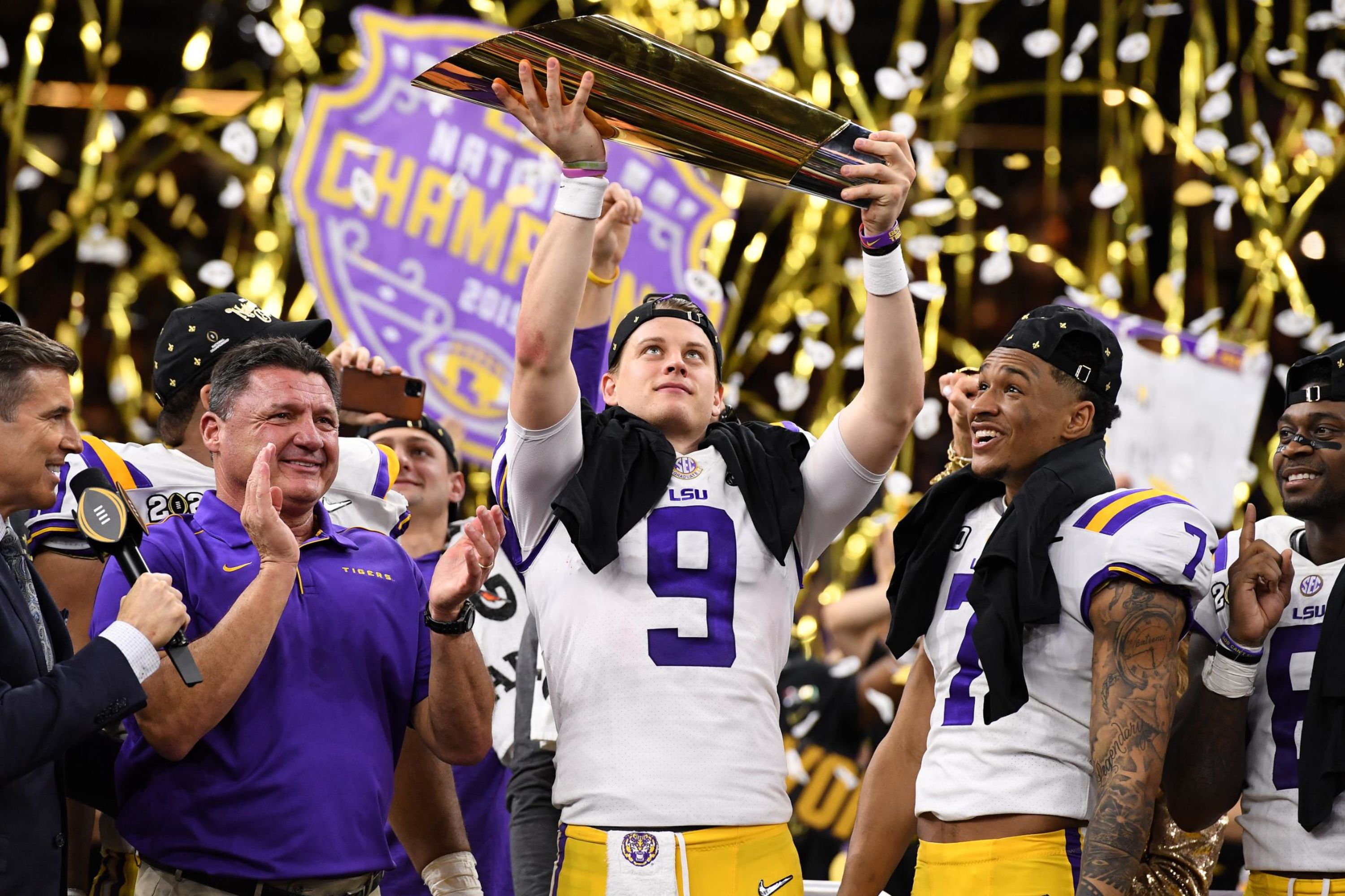 LSU quarterback Joe Burrow lifts the trophy after Monday night's win over Clemson.