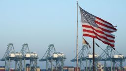An American flag flies nearby with shipping containers stacked at the Port of Los Angeles in the background, which is the nation's busiest container port, on November 7, 2019 in San Pedro, California.